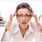 woman with glasses being stressed at work